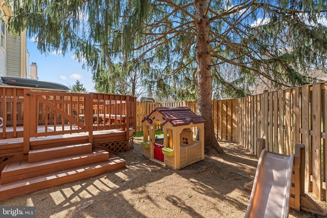 exterior space featuring a fenced backyard and a wooden deck