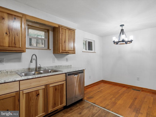 kitchen with visible vents, dark wood finished floors, light countertops, stainless steel dishwasher, and a sink