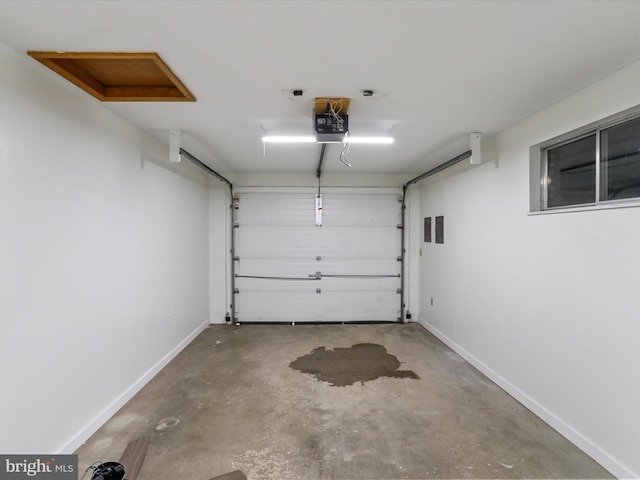 garage featuring baseboards and a garage door opener