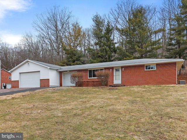 single story home with brick siding, a front yard, and a garage