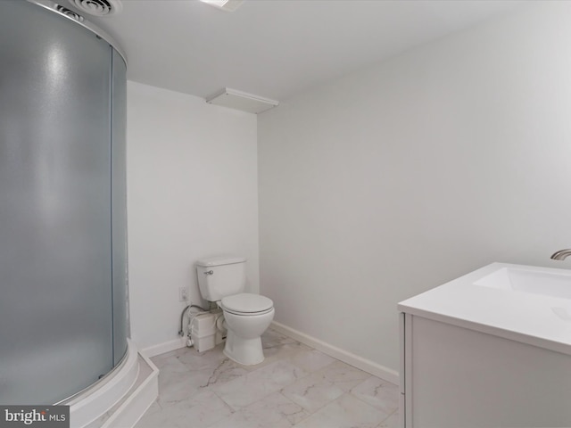 bathroom featuring marble finish floor, toilet, a shower stall, and baseboards