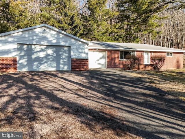 view of front of property with an outbuilding and brick siding