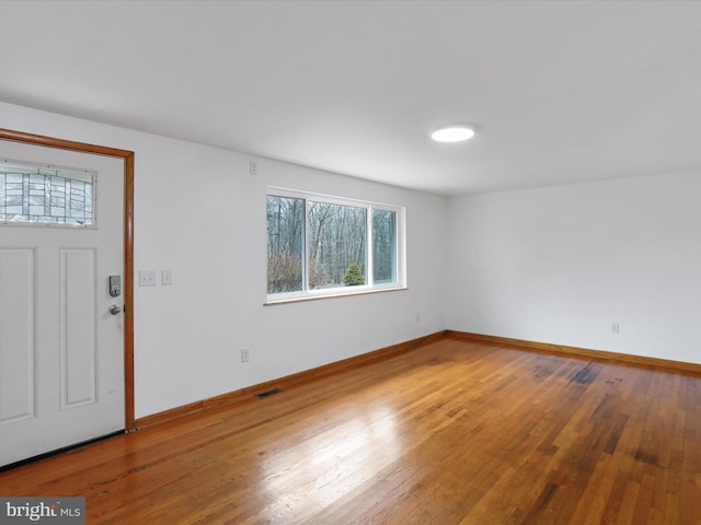 entrance foyer with visible vents, baseboards, and hardwood / wood-style flooring