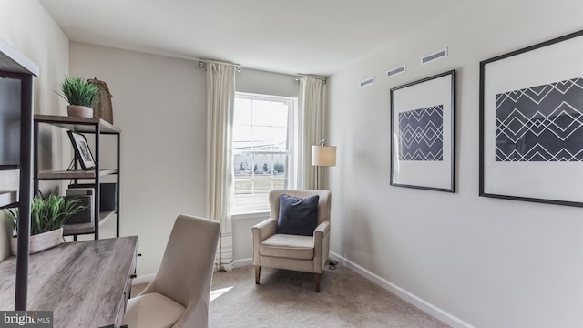 carpeted home office featuring visible vents and baseboards