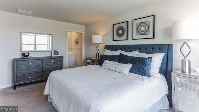 carpeted bedroom with baseboards, visible vents, and connected bathroom