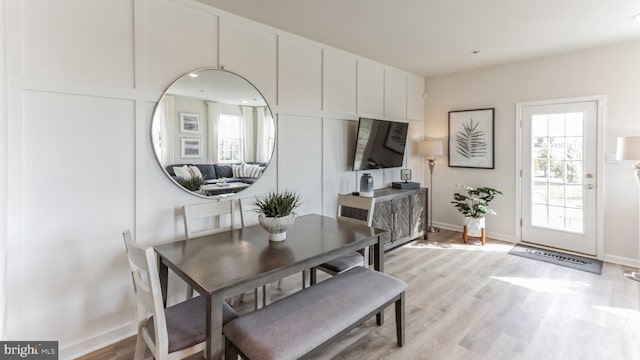 dining room with light wood-type flooring and baseboards