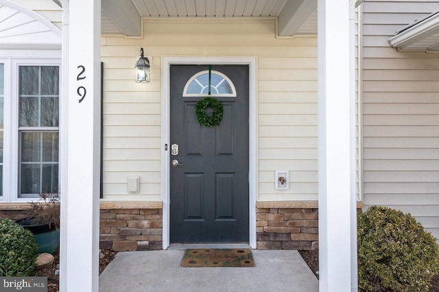 doorway to property featuring stone siding