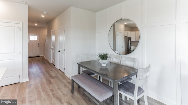 dining room featuring recessed lighting, baseboards, and light wood-type flooring