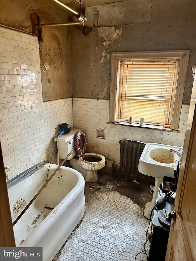 full bathroom with radiator, a sink, tile patterned floors, toilet, and a washtub