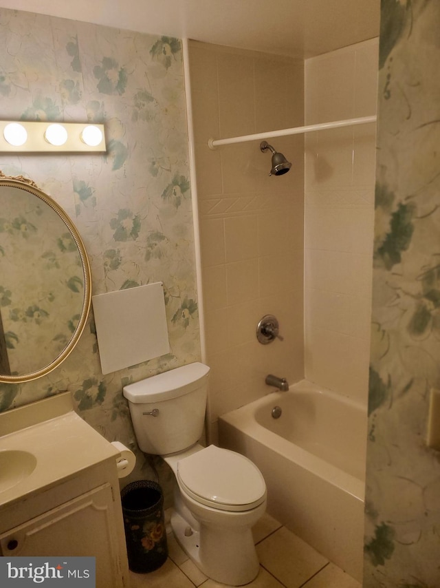 bathroom with vanity, washtub / shower combination, wallpapered walls, tile patterned floors, and toilet