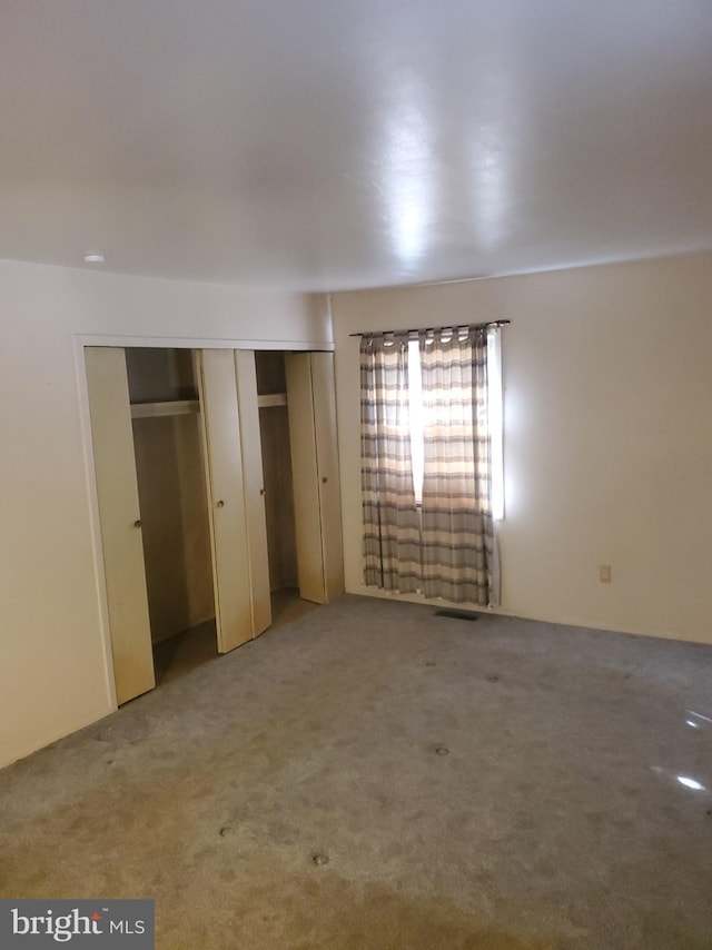 unfurnished bedroom with visible vents and carpet floors