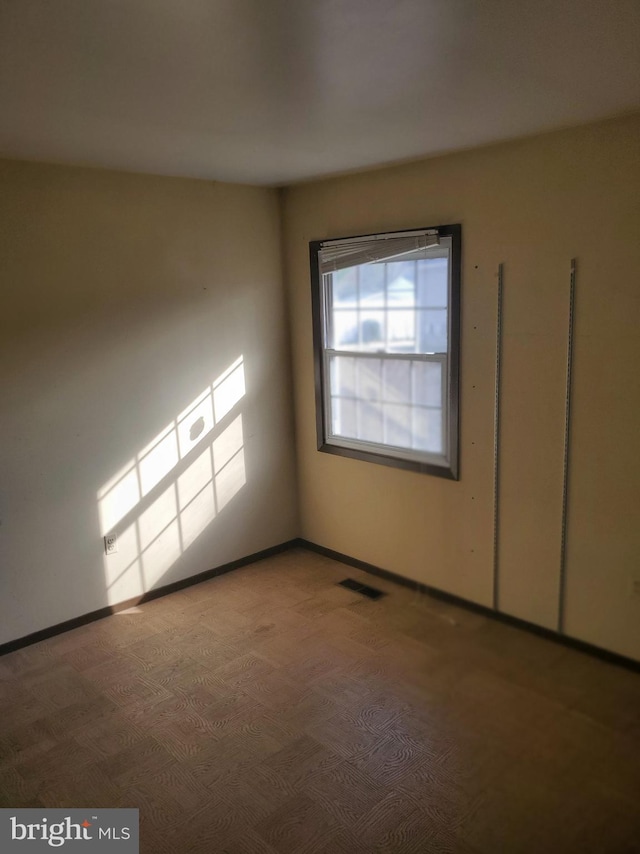 unfurnished bedroom with visible vents and baseboards