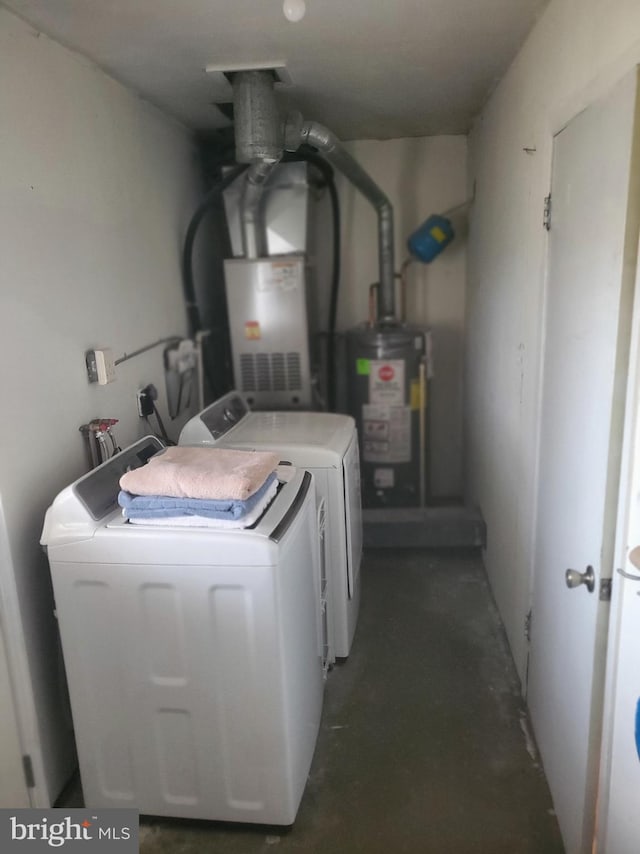 washroom featuring laundry area, washing machine and dryer, and gas water heater