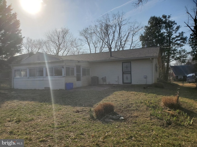 rear view of house with a lawn