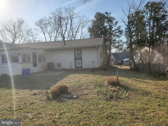 back of property with cooling unit, a lawn, and a patio area