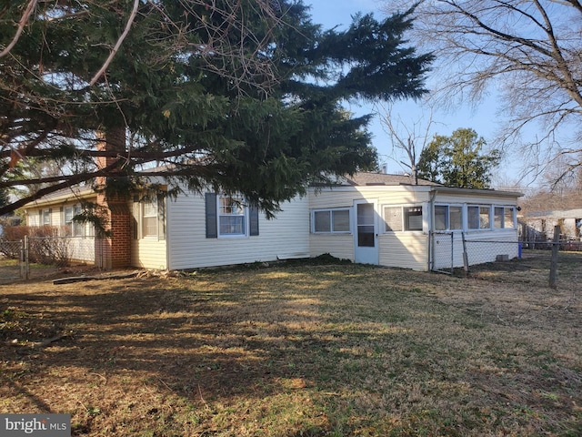 back of house with a yard and fence