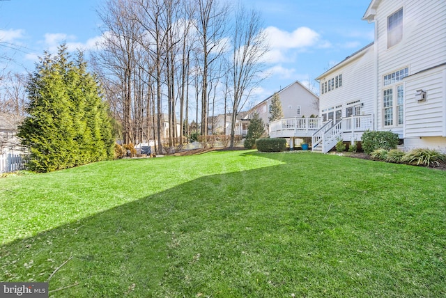 view of yard featuring a deck and stairs