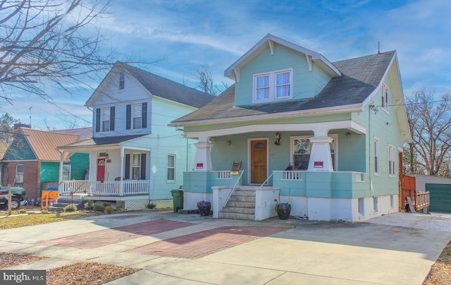 bungalow-style home with covered porch and driveway