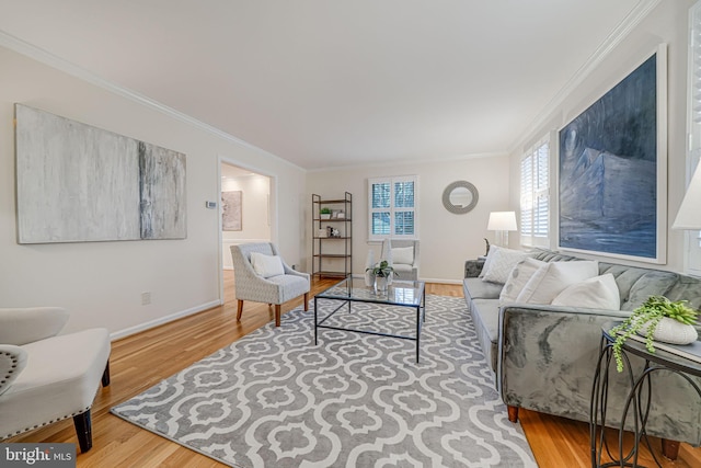 living room with baseboards, wood finished floors, and ornamental molding