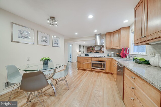 kitchen with a sink, stainless steel dishwasher, tasteful backsplash, island range hood, and white gas cooktop