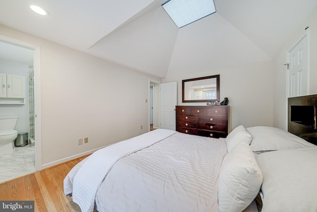 bedroom featuring recessed lighting, connected bathroom, vaulted ceiling with skylight, light wood finished floors, and baseboards