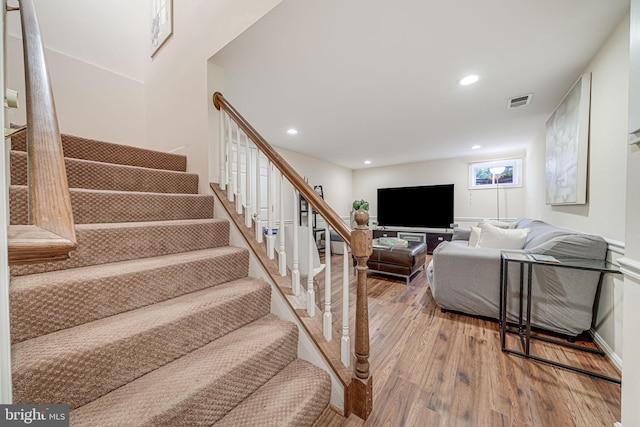 stairway with recessed lighting, visible vents, and hardwood / wood-style floors