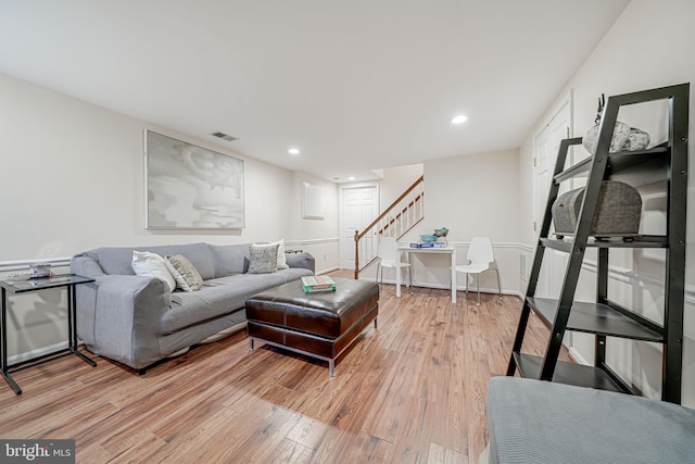 living room featuring stairs, recessed lighting, visible vents, and light wood finished floors