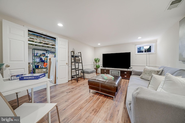 living area featuring light wood-style flooring, recessed lighting, and visible vents