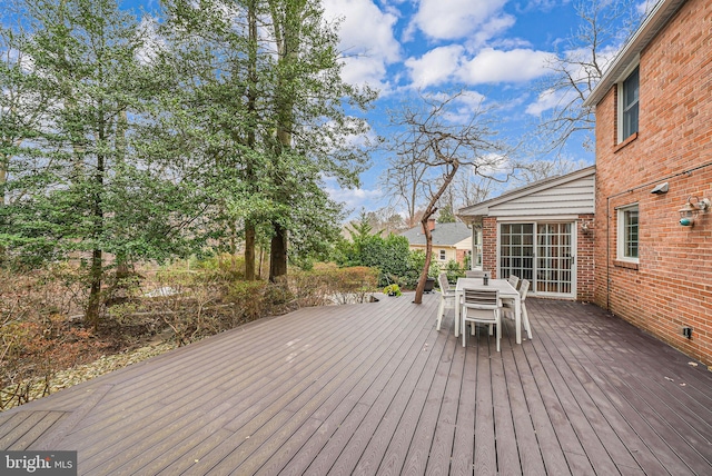 wooden terrace featuring outdoor dining area