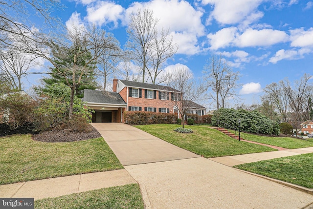 view of front facade featuring a front lawn, an attached garage, driveway, and a chimney