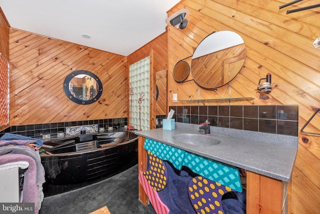 full bathroom with vanity, wooden walls, and a bath