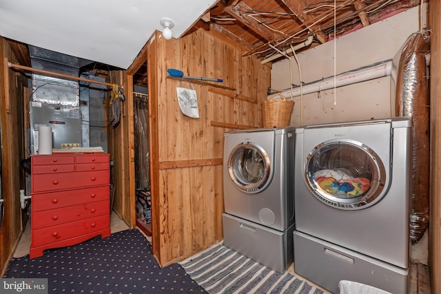 laundry room featuring laundry area, independent washer and dryer, and wood walls