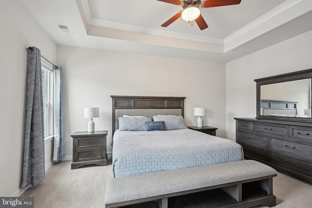 bedroom with visible vents, baseboards, a raised ceiling, light colored carpet, and ceiling fan