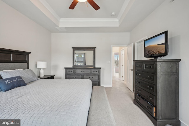 bedroom featuring light colored carpet, a ceiling fan, a raised ceiling, and baseboards