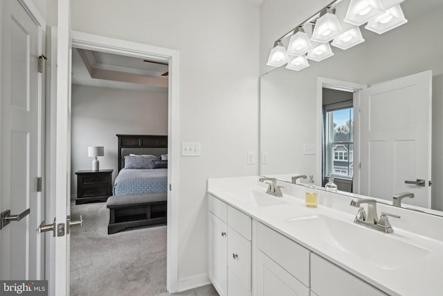 full bath featuring double vanity, ensuite bathroom, and a sink