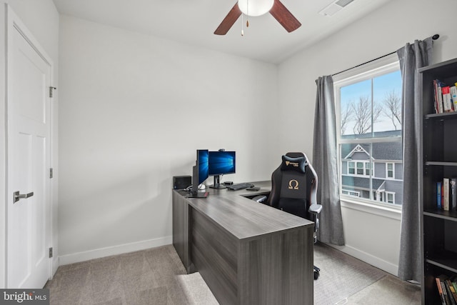 office area with visible vents, baseboards, light carpet, and ceiling fan