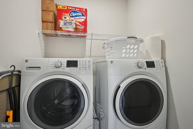 washroom featuring laundry area and washer and clothes dryer