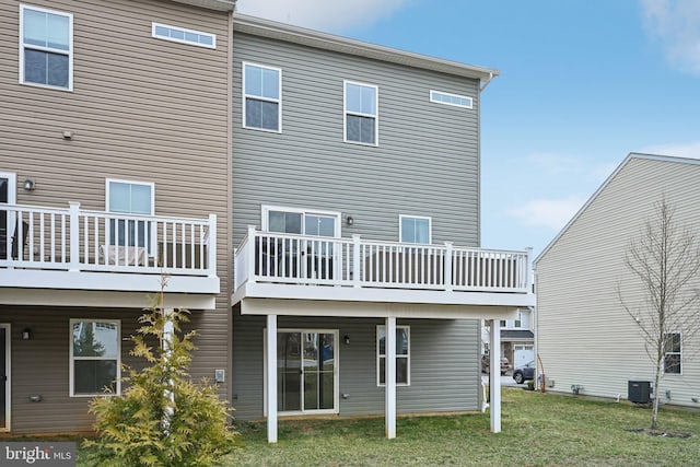 rear view of house featuring a yard and central AC unit