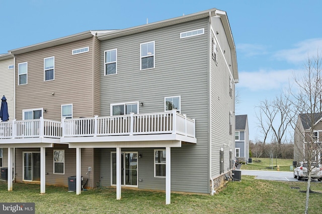 back of house featuring a deck and a yard