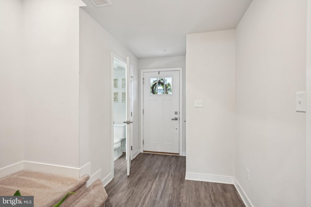 entryway featuring baseboards and wood finished floors