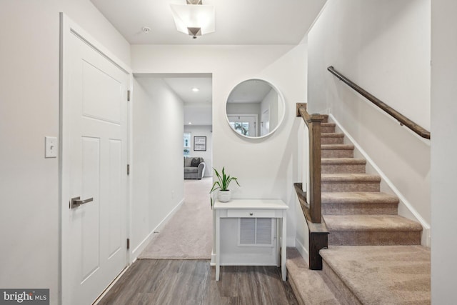 stairway featuring baseboards and wood finished floors