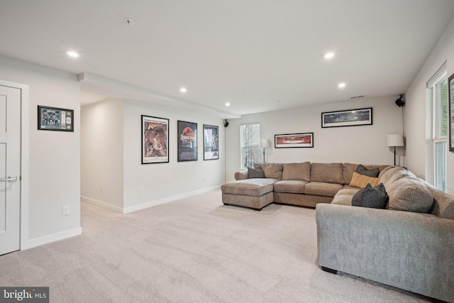 living room featuring recessed lighting, light colored carpet, and baseboards