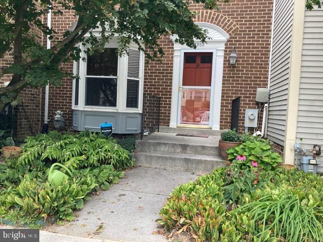 property entrance featuring brick siding