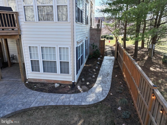 view of home's exterior with fence