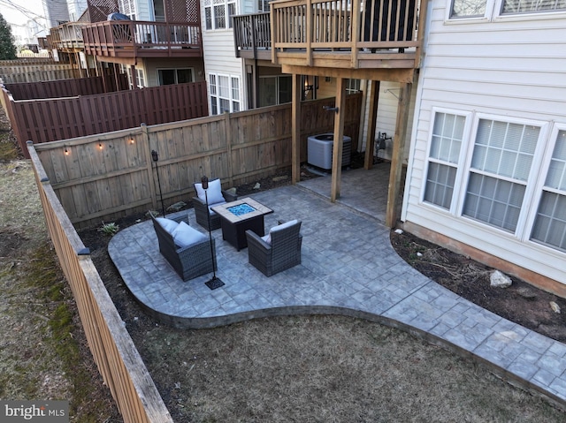 view of patio featuring central air condition unit, an outdoor living space with a fire pit, and fence