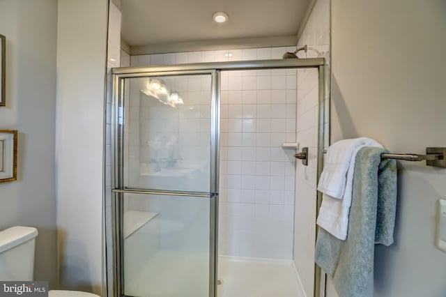 full bath with a shower stall and toilet