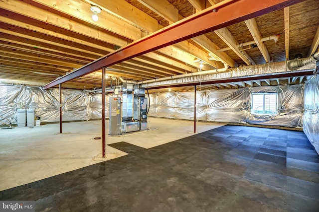 below grade area featuring heating unit and water heater