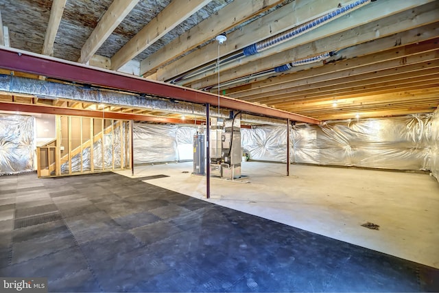 unfinished basement with heating unit and water heater