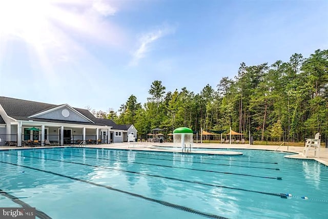 community pool featuring a patio and fence
