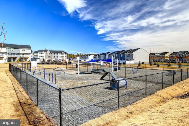 view of community with a residential view and fence